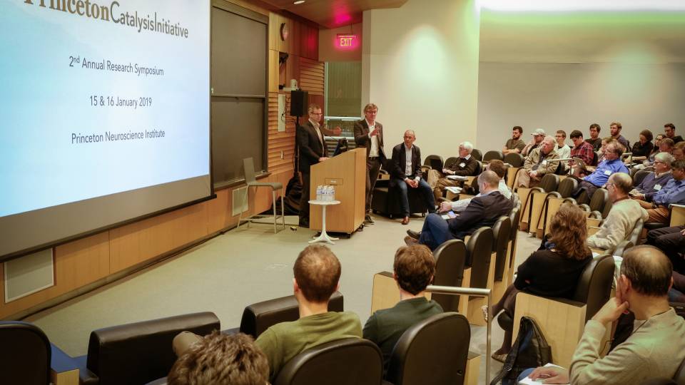 Paul Chirik and David Macmillan at a podium, answering questions from the audience