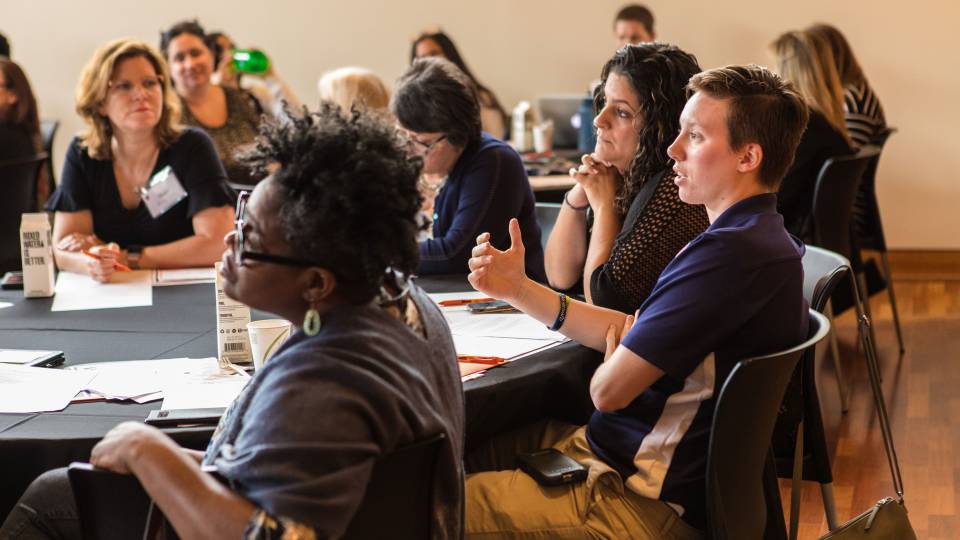 A group at a table speaking during the seminar