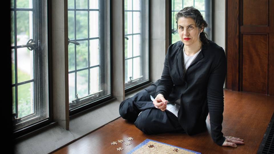 Marina Rustow in front of a jigsaw puzzle