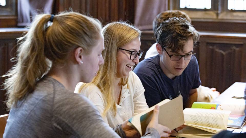 Students discuss the work in groups