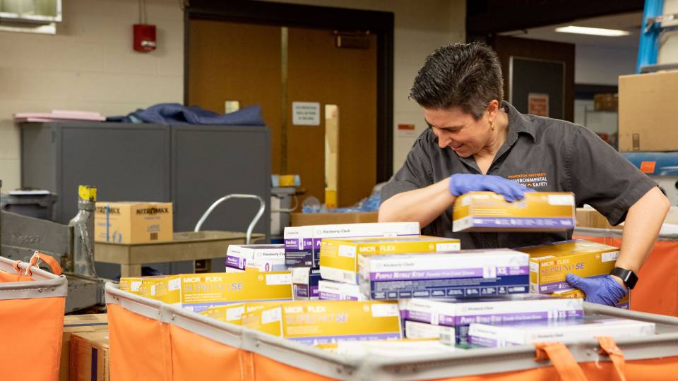 Kelly States sorts through boxes of PPE