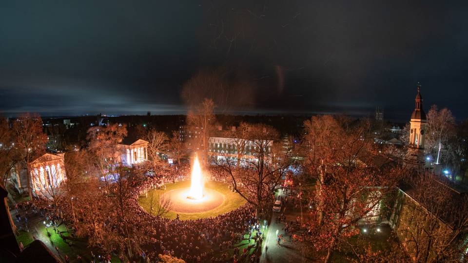 Aerial shot of crowds and bonfire behind Nassau Hall