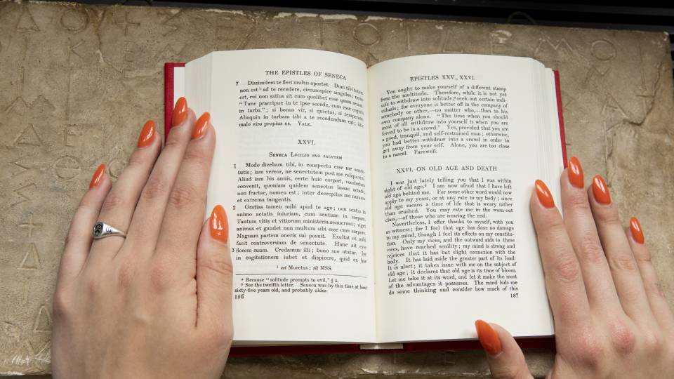 Book open to Latin/English texts of the epistles of Seneca.