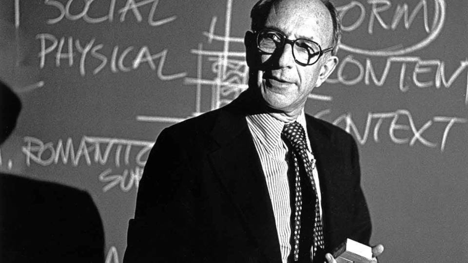 Robert Geddes in front of a blackboard 