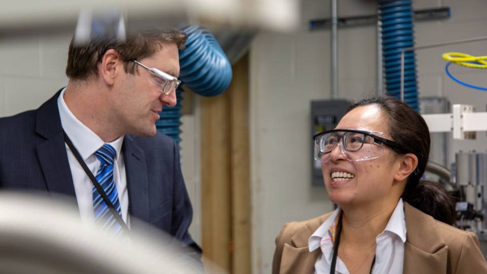 Two individuals talking in a lab