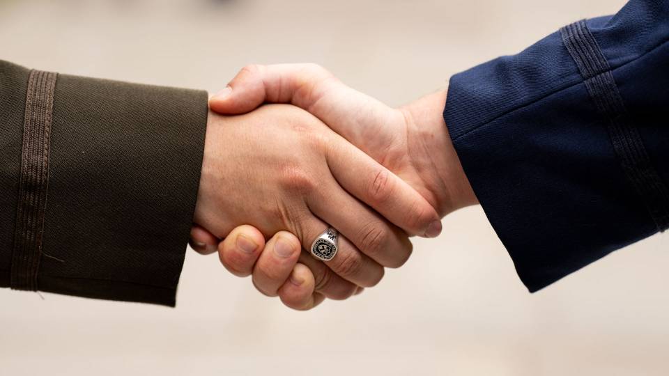 Closeup of a handshake at the Commissioning ceremony