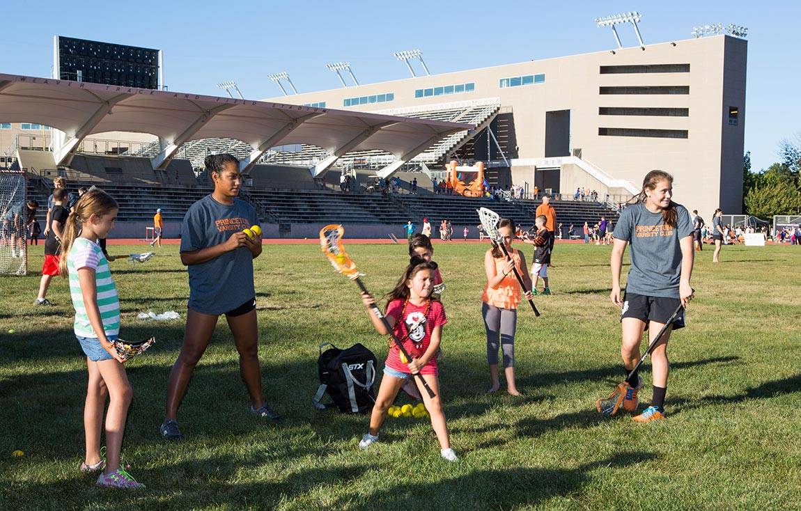 Youth Campus Community Staff Day coaching lacrosse to children