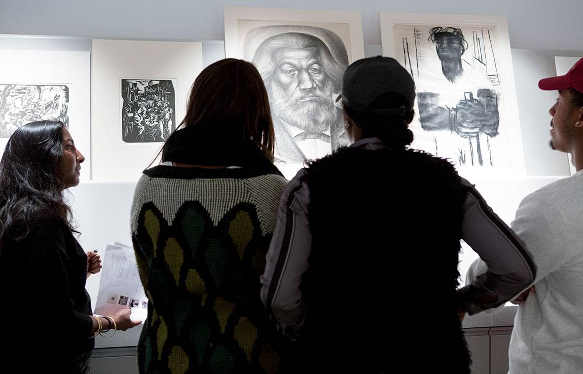Students in 'Enter the New Negro: Black Atlantic Aesthetics,' taught by Anna Arabindan-Kesson, assistant professor of art and archaeology and African American studies (left), discuss original art works in a study room at the Princeton University Art Museum. 