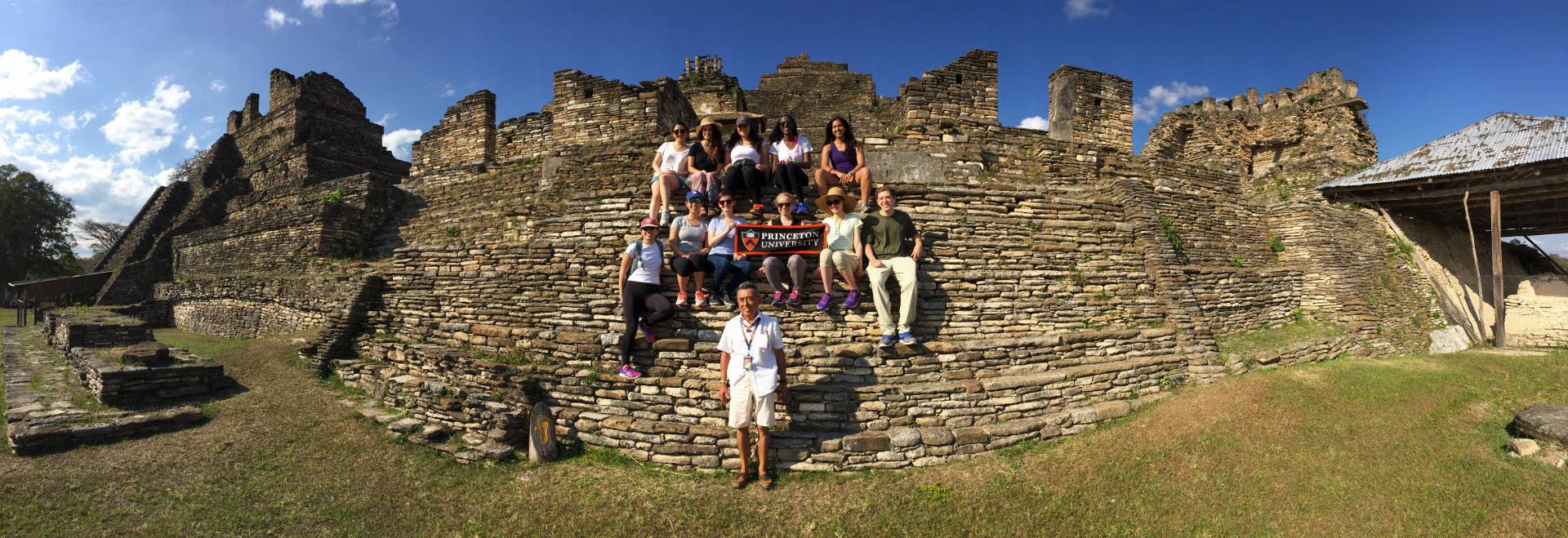 Students and guide with Princeton University banner at ruins