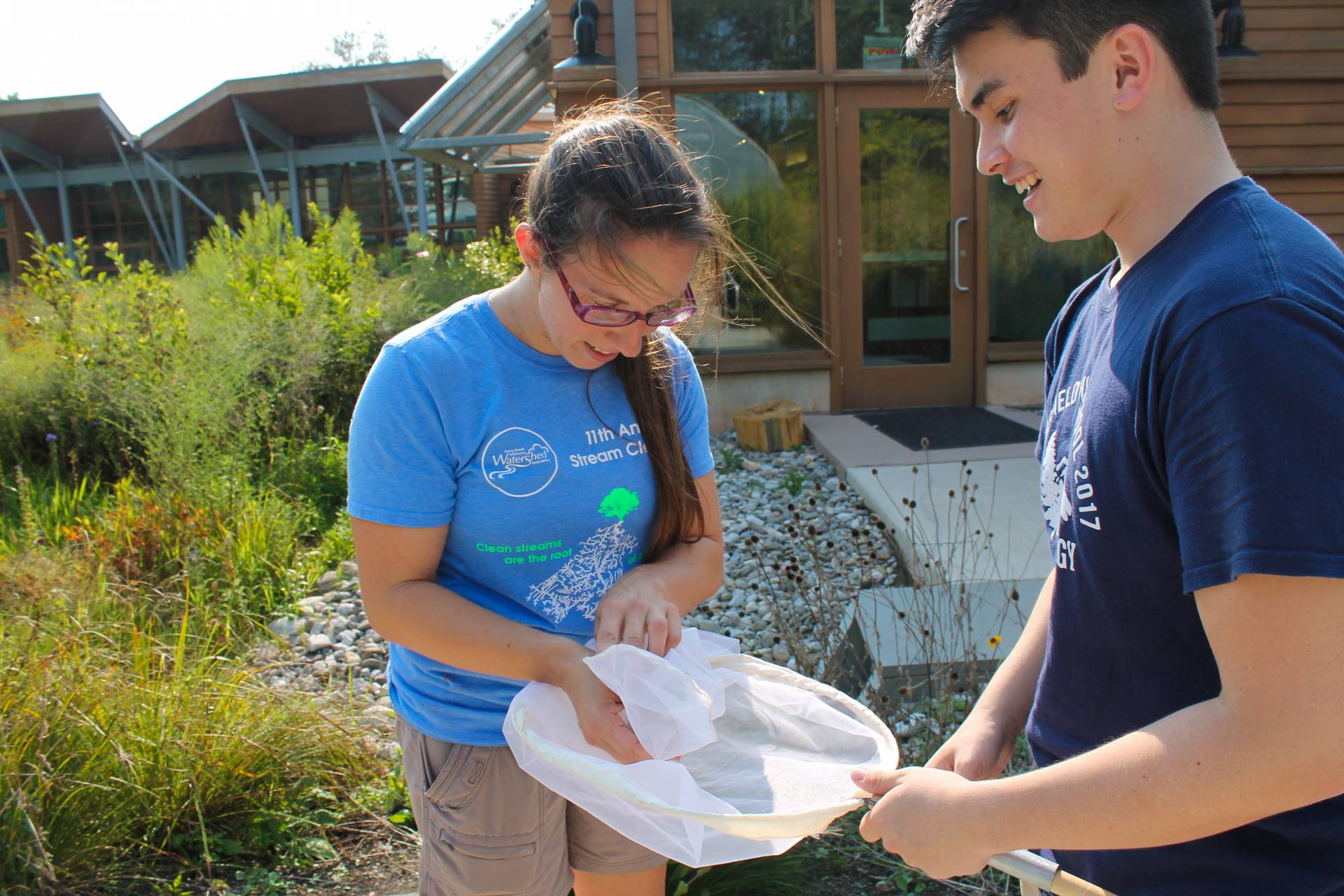 Student holds a butterfly net for naturalist