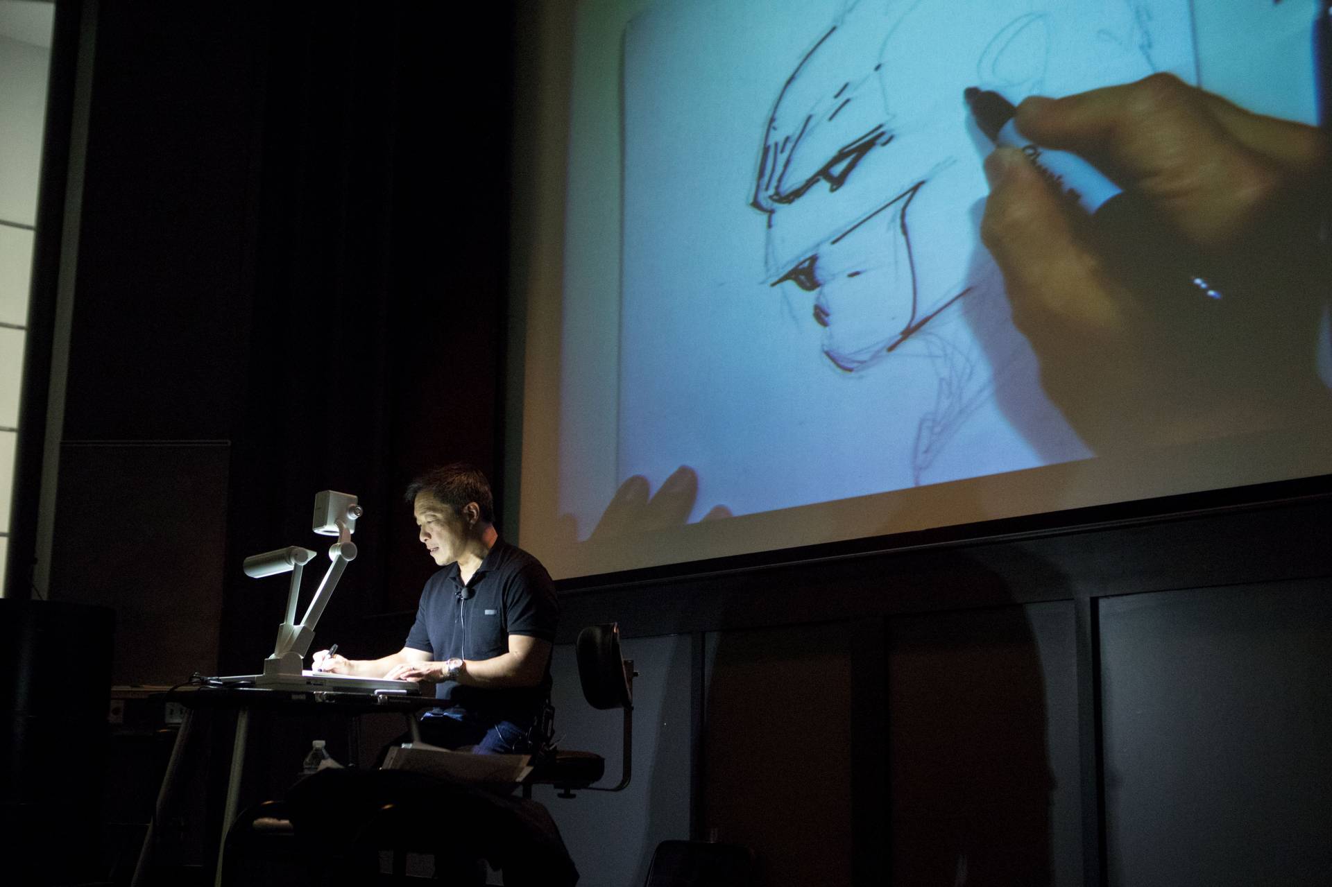 Jim Lee sketching at podium