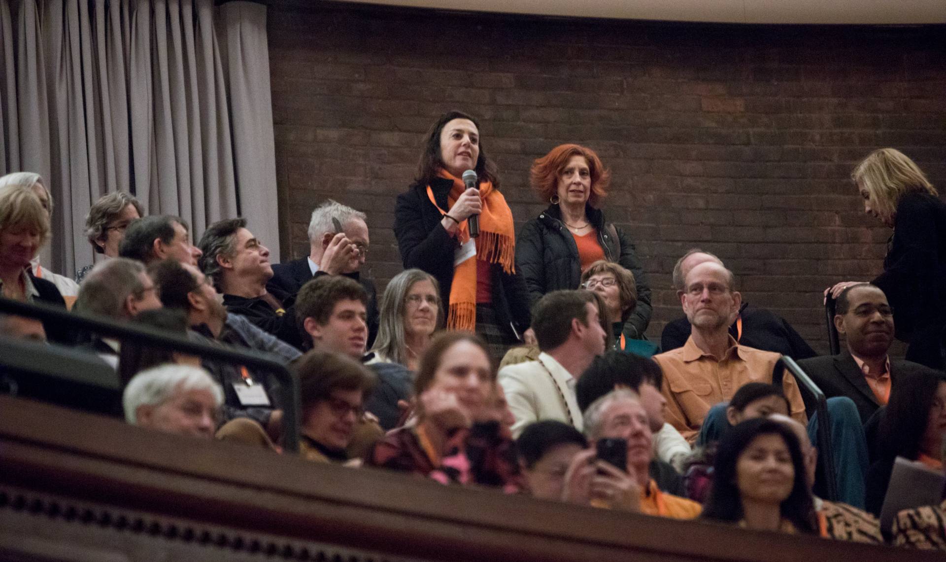 A woman asks a question during Alumni Day Q&A session