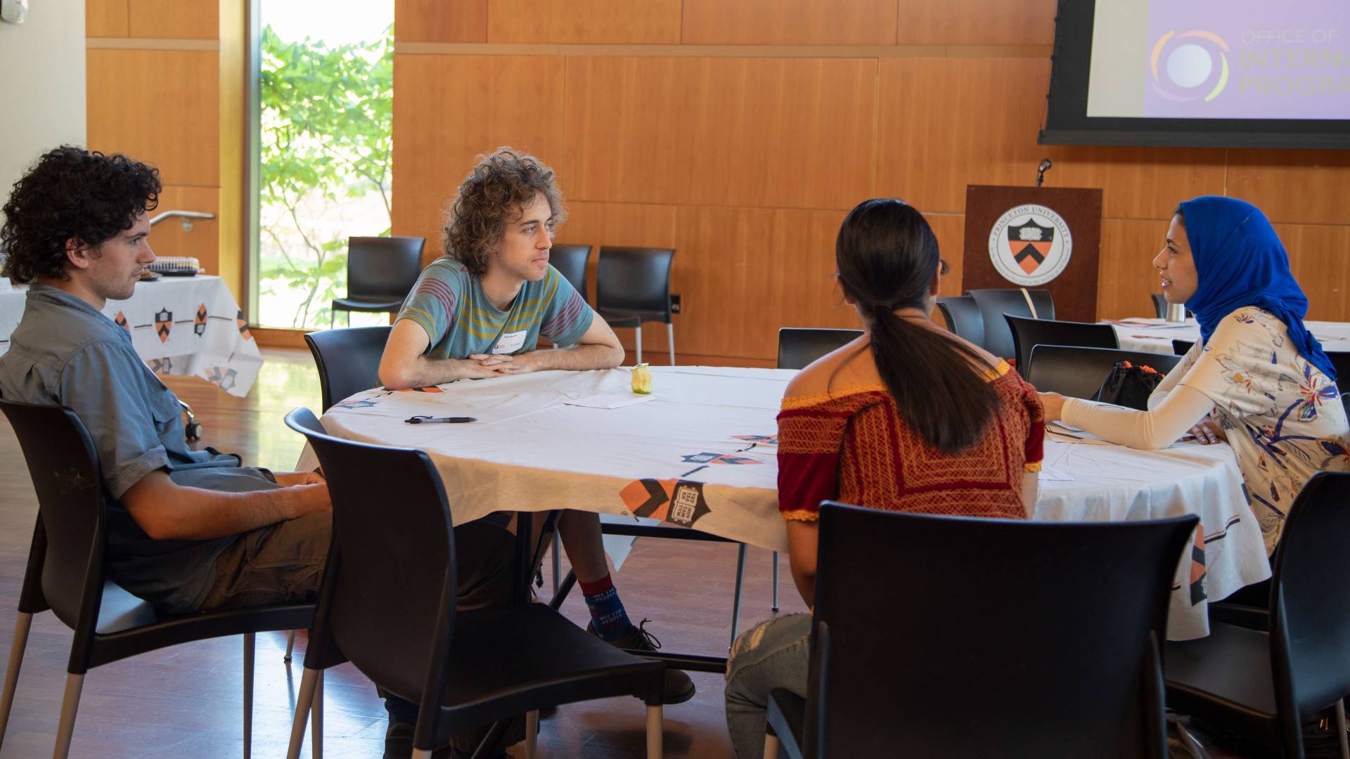 Kyle Berlin, Preston Evers, Gabriela Oseguera Serra and Alaa Ragab sitting at a table
