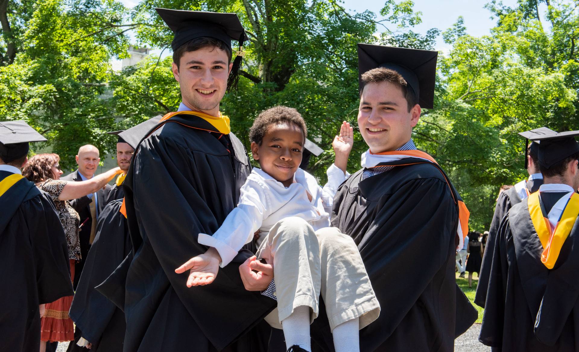 Roan Gideon and Jon Lebeau cradling younger brother