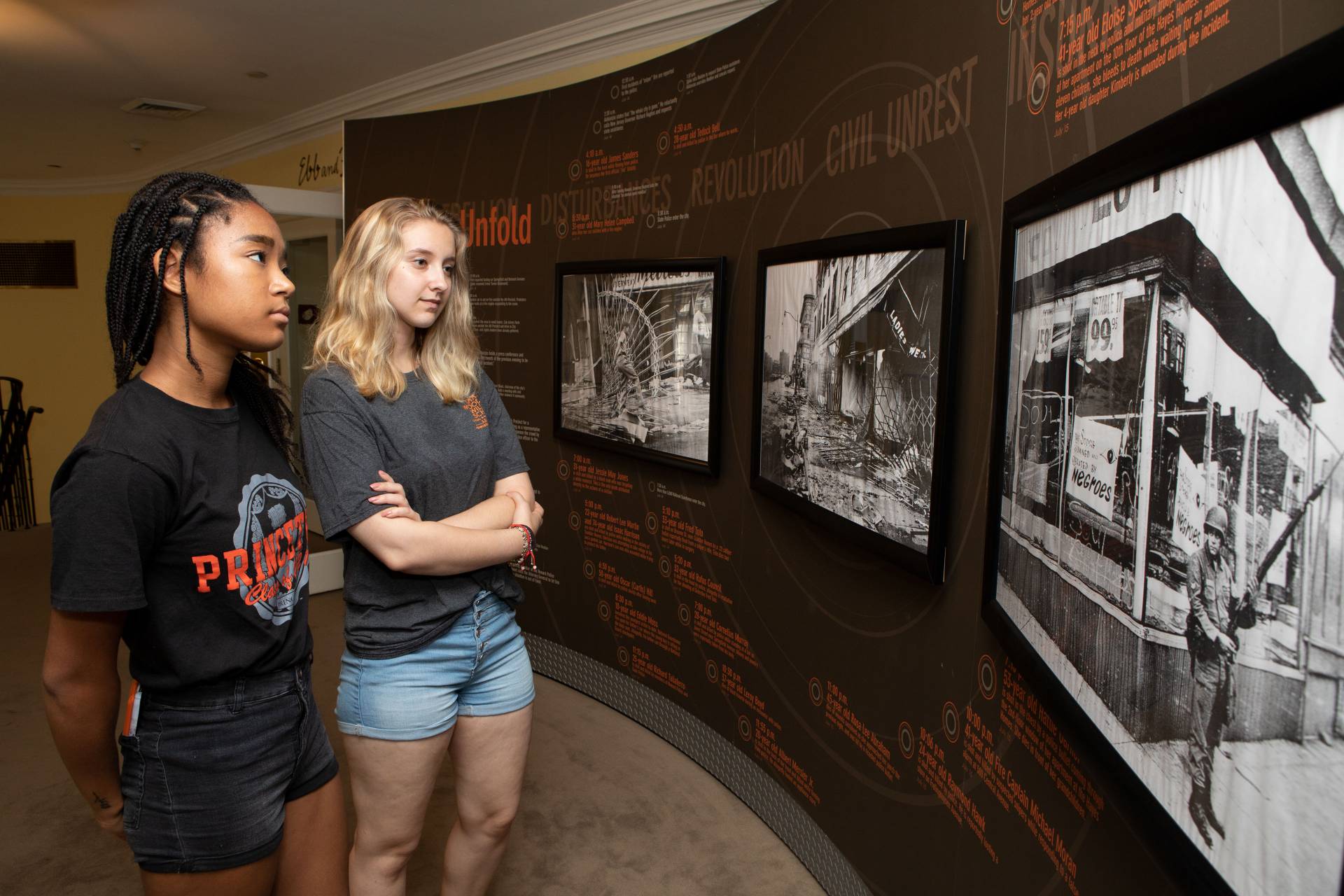 Ann Bogdan and Masha Miura looking at timeline of 1967 Newark riots