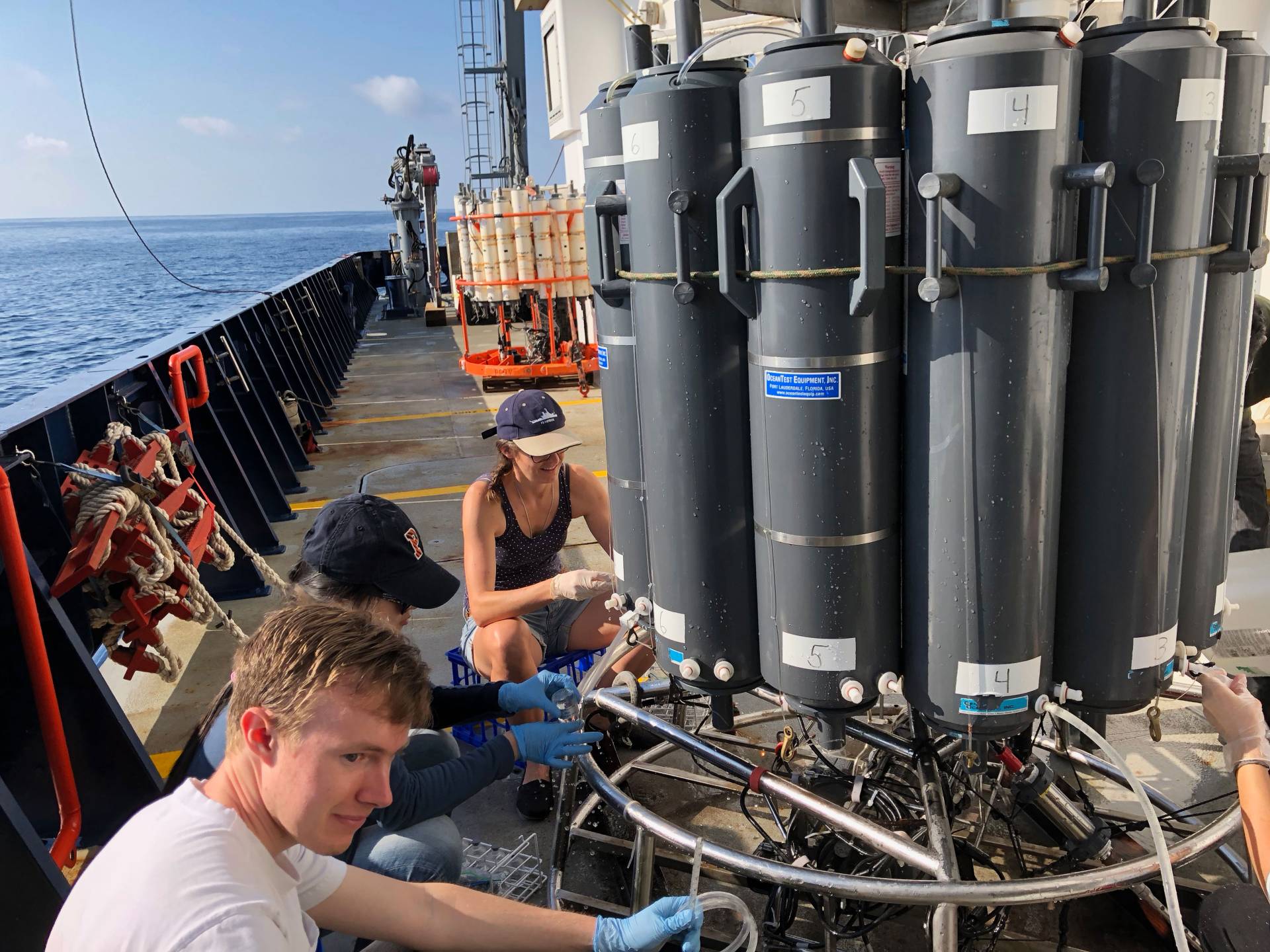 John Tracey working on ship putting samples into bottles