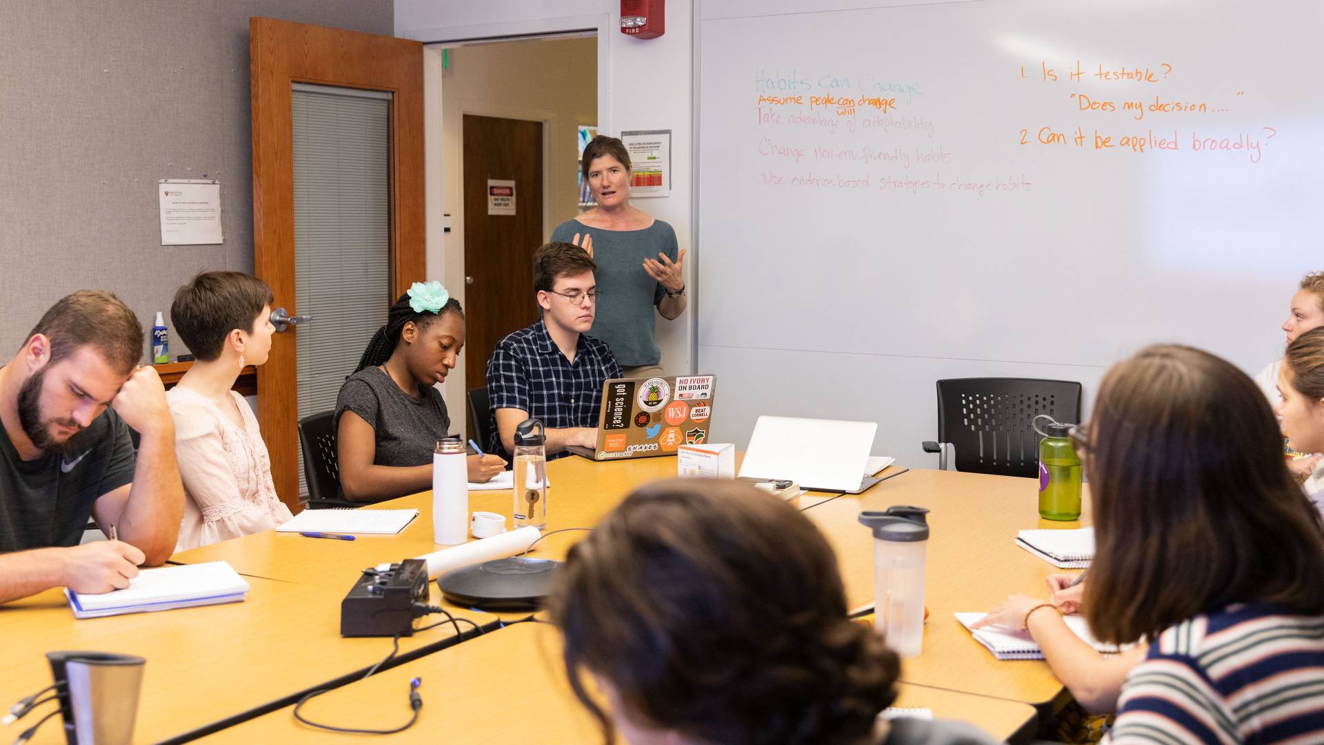 Shana Webber at whiteboard teaching a class