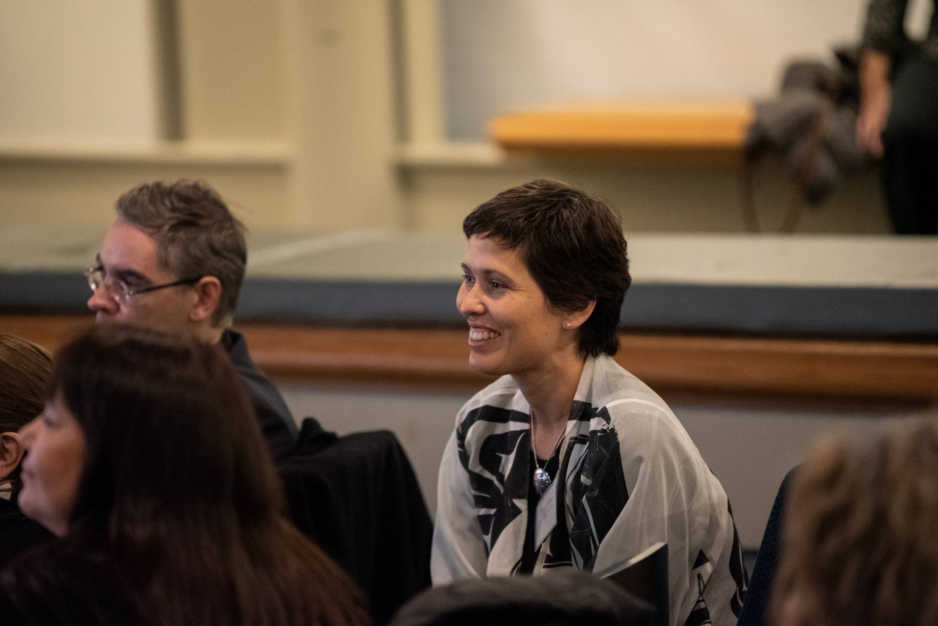 Candis Callison smiles while sitting in the audience