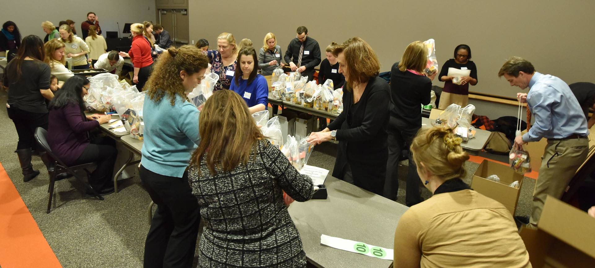 University staff putting food into plastic bags