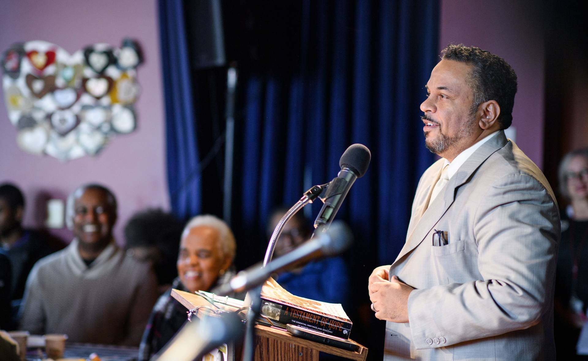 Rev. Lukata Mjumbe speaking at podium