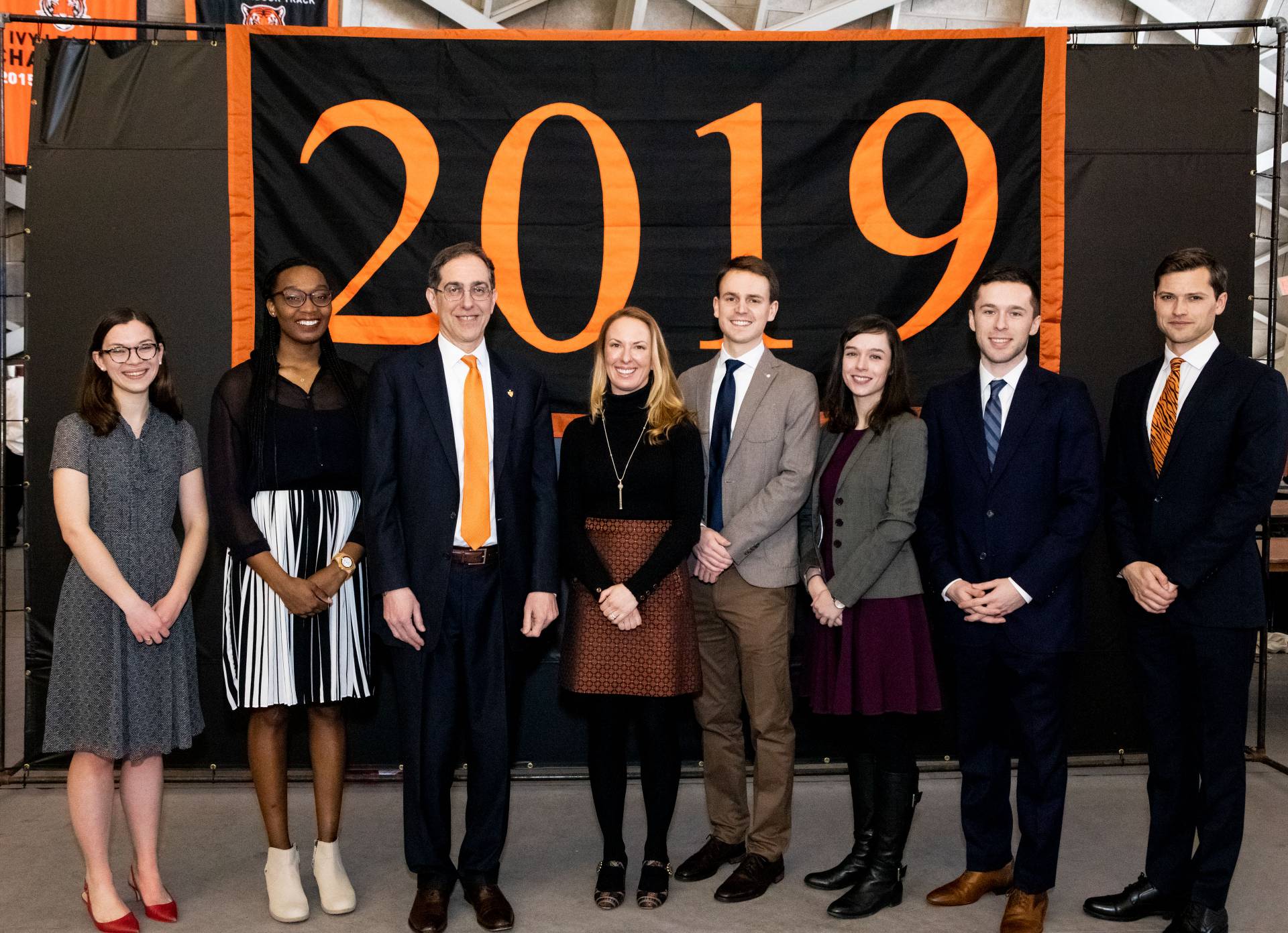 Award winners standing with President Eisgruber under 2019 banner
