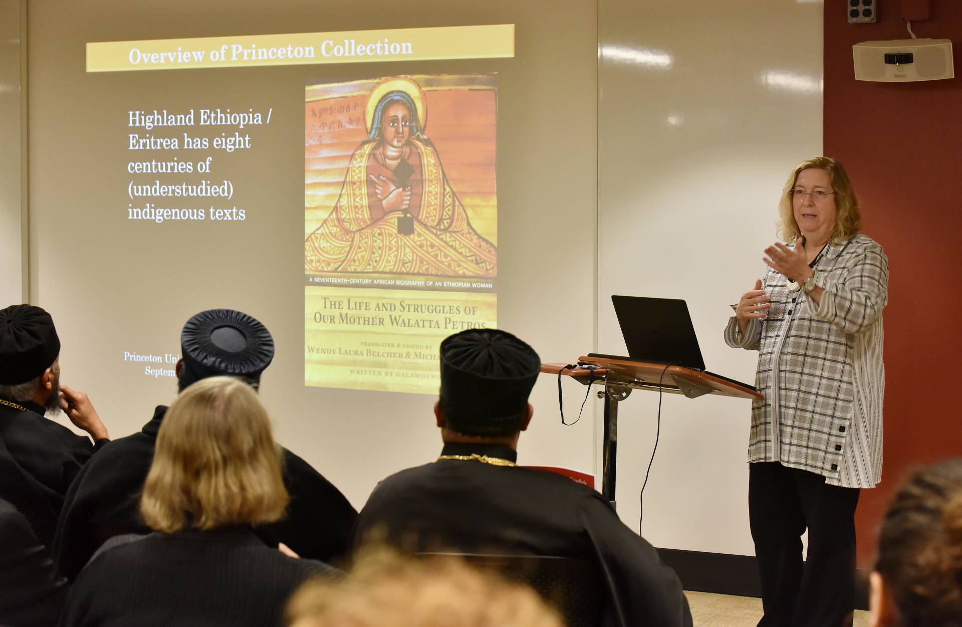 Wendy Belcher talking about one of her slides and a small section of the audience