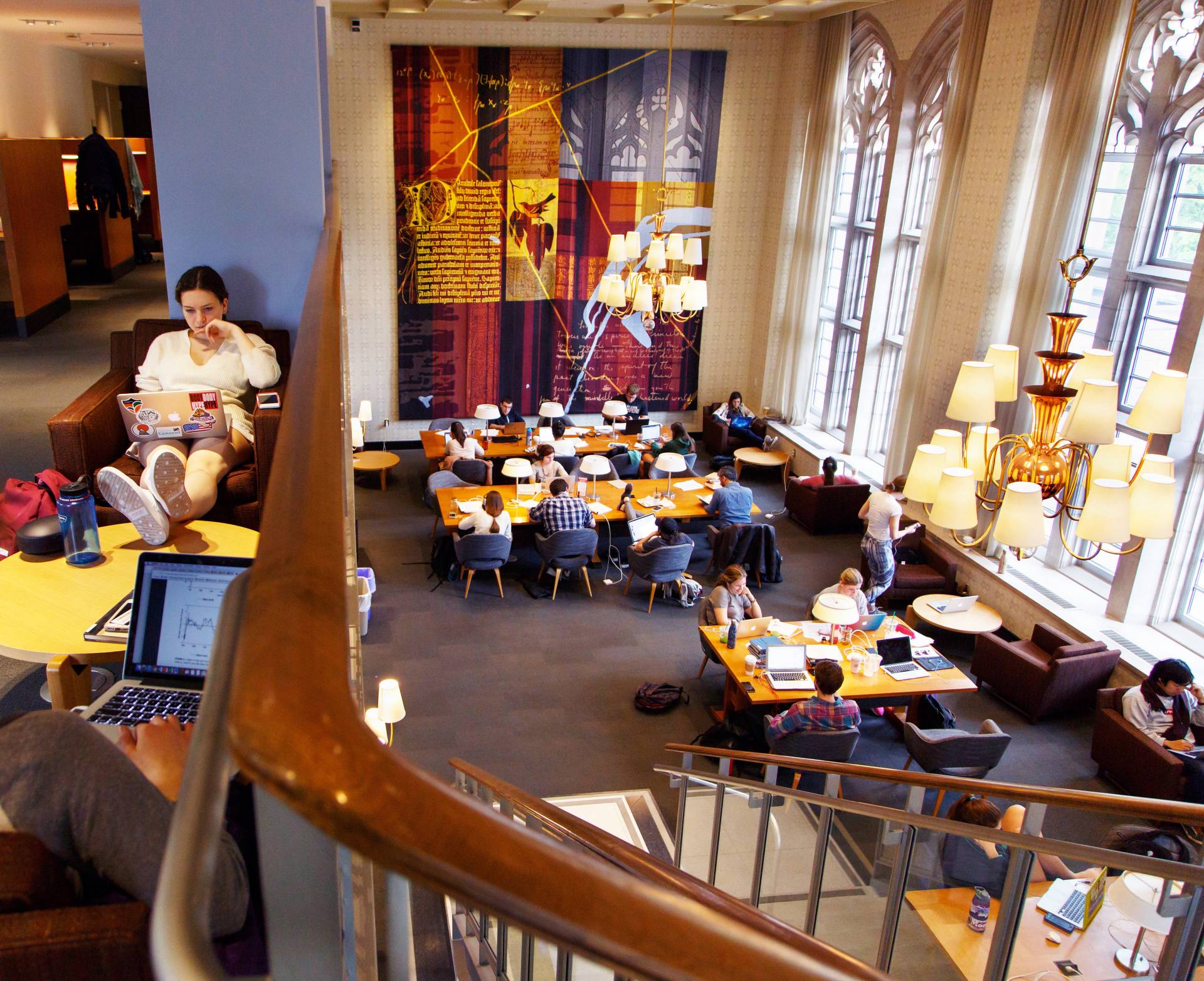 Students studying in multiple areas in library