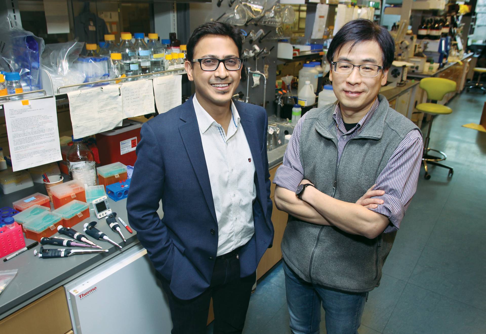 Kaushik Sengupta and Haw Yang stand in a chemistry laboratory