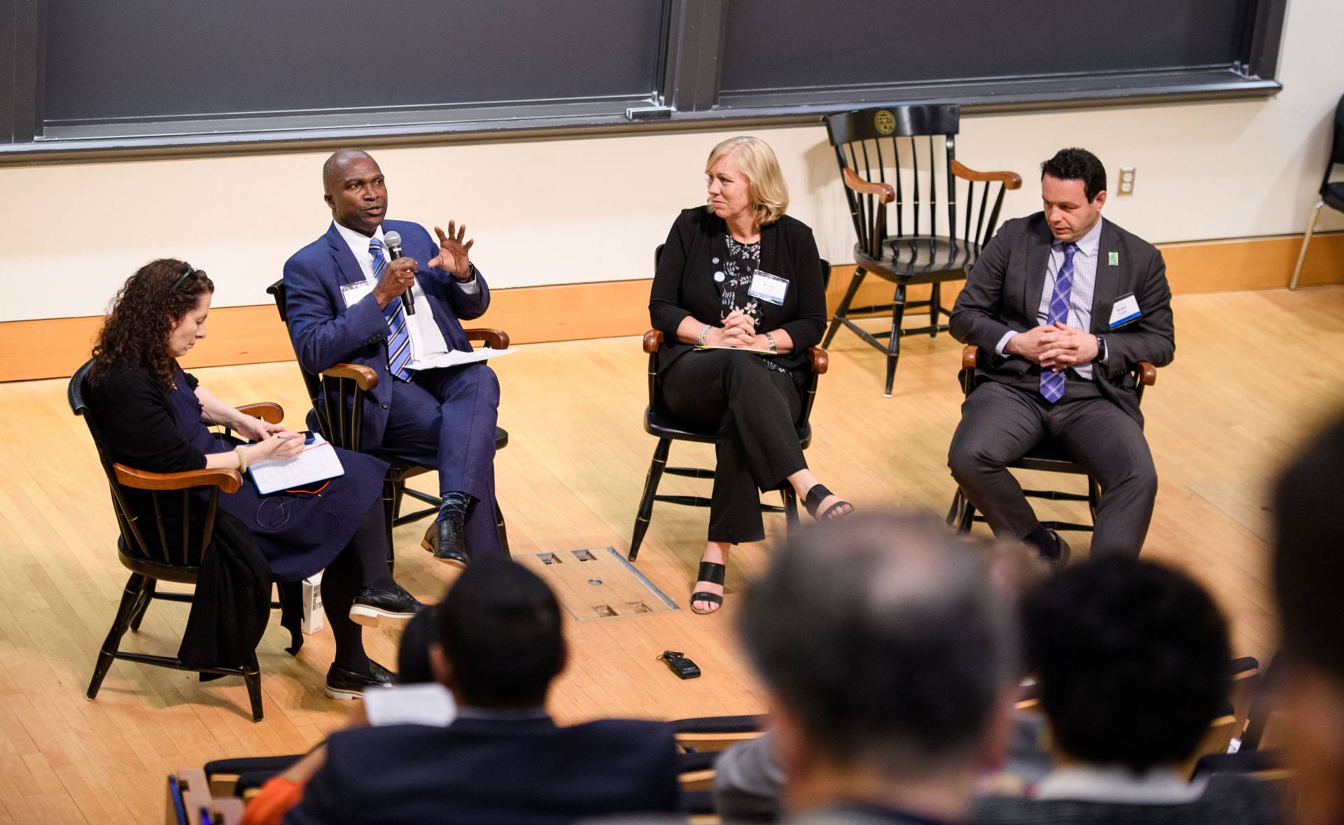 A panel of speakers on a stage