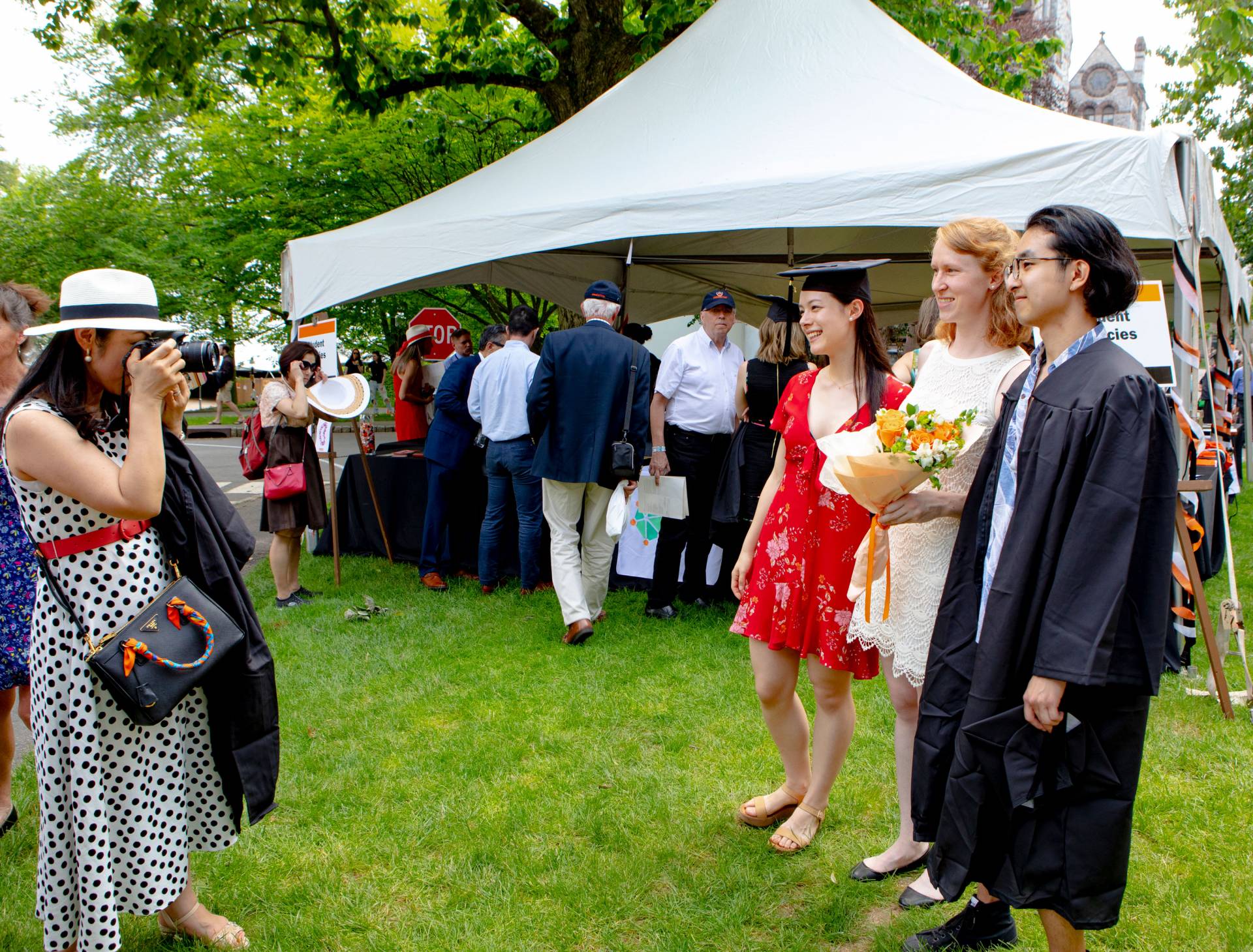 Students posing for a family member taking photos