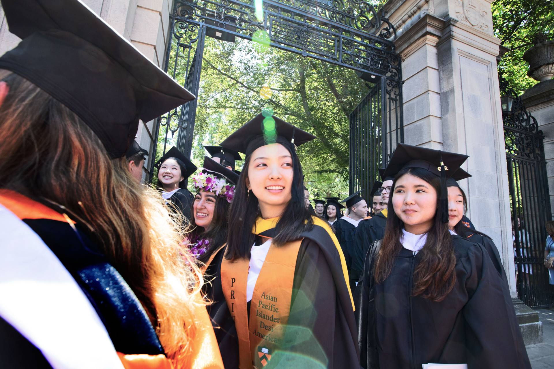 Students walking out of the gate after Commencement
