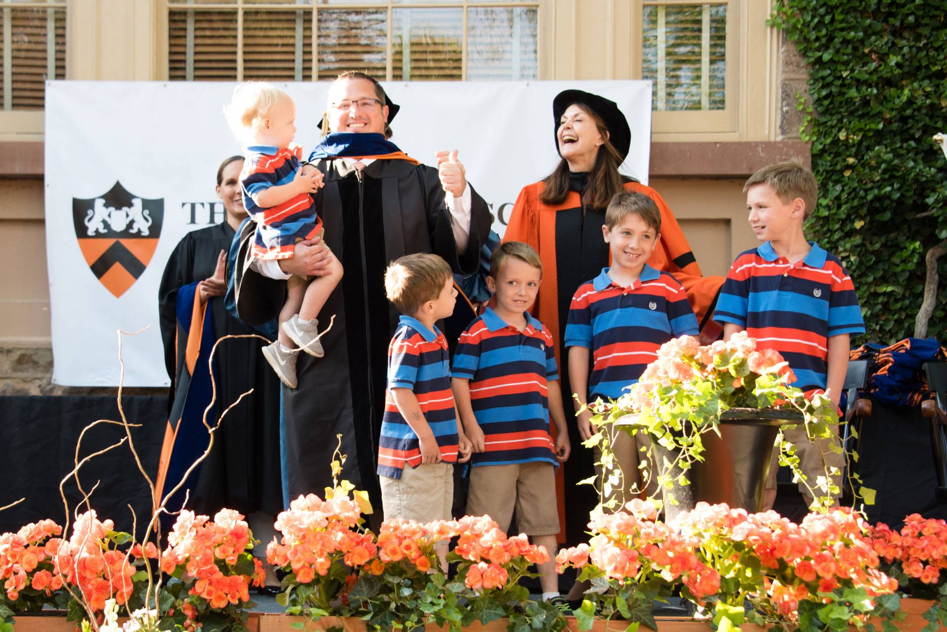 Rober Harrison receiving his hood on stage with family