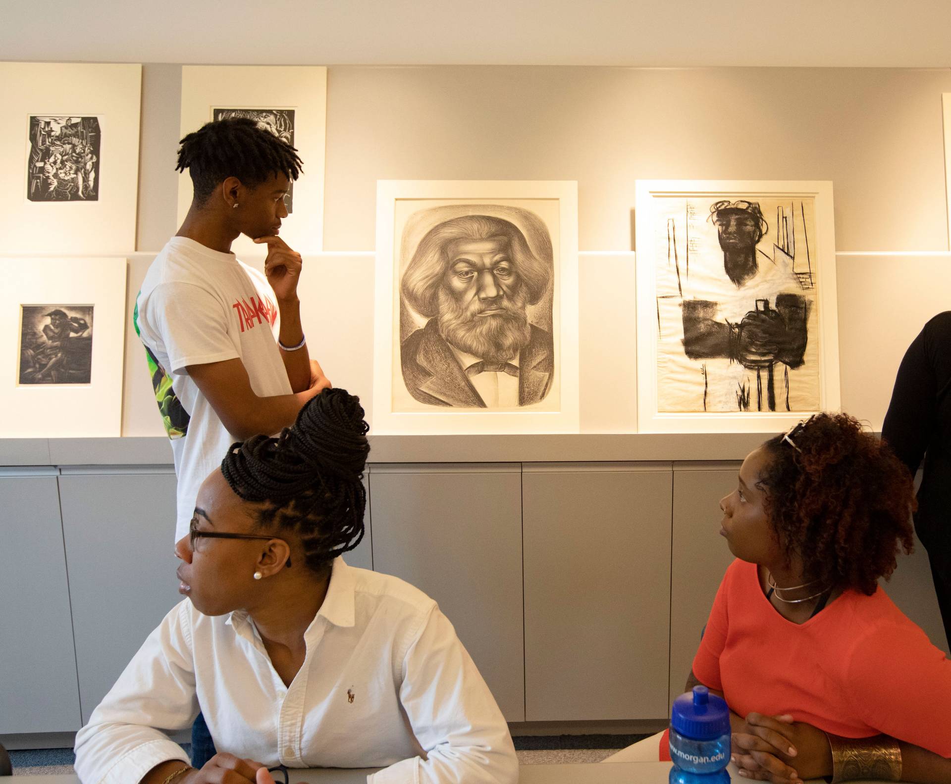 A student contemplates a portrait of Frederick Douglas