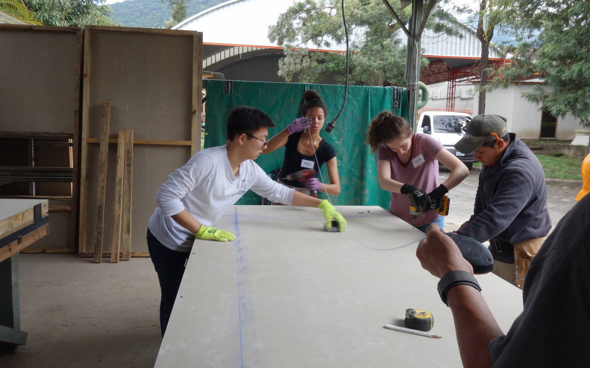 3 students involved in a construction task