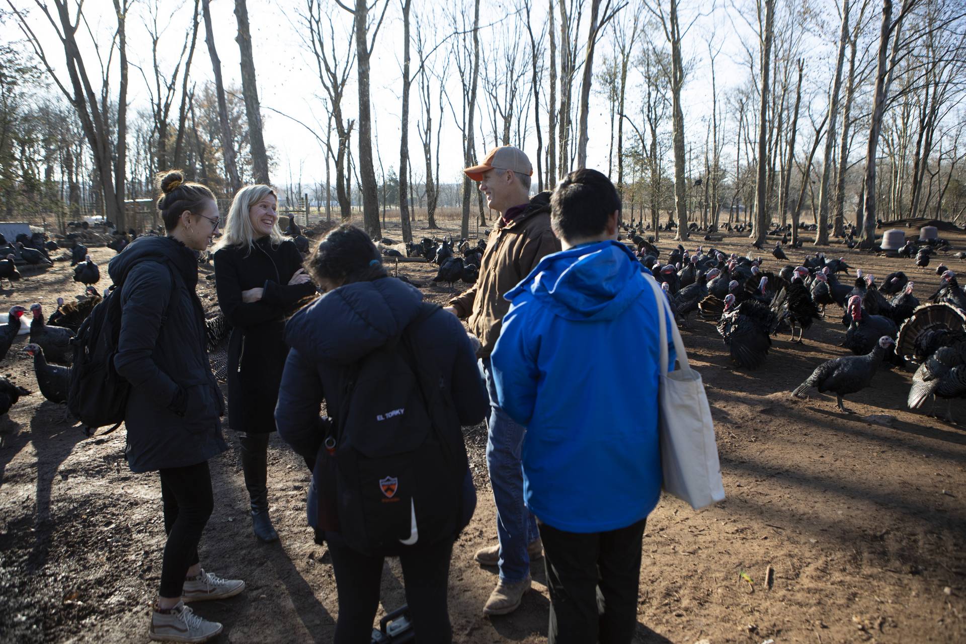 Carruth and the farmer laugh as the 3 students prepare to record their interview