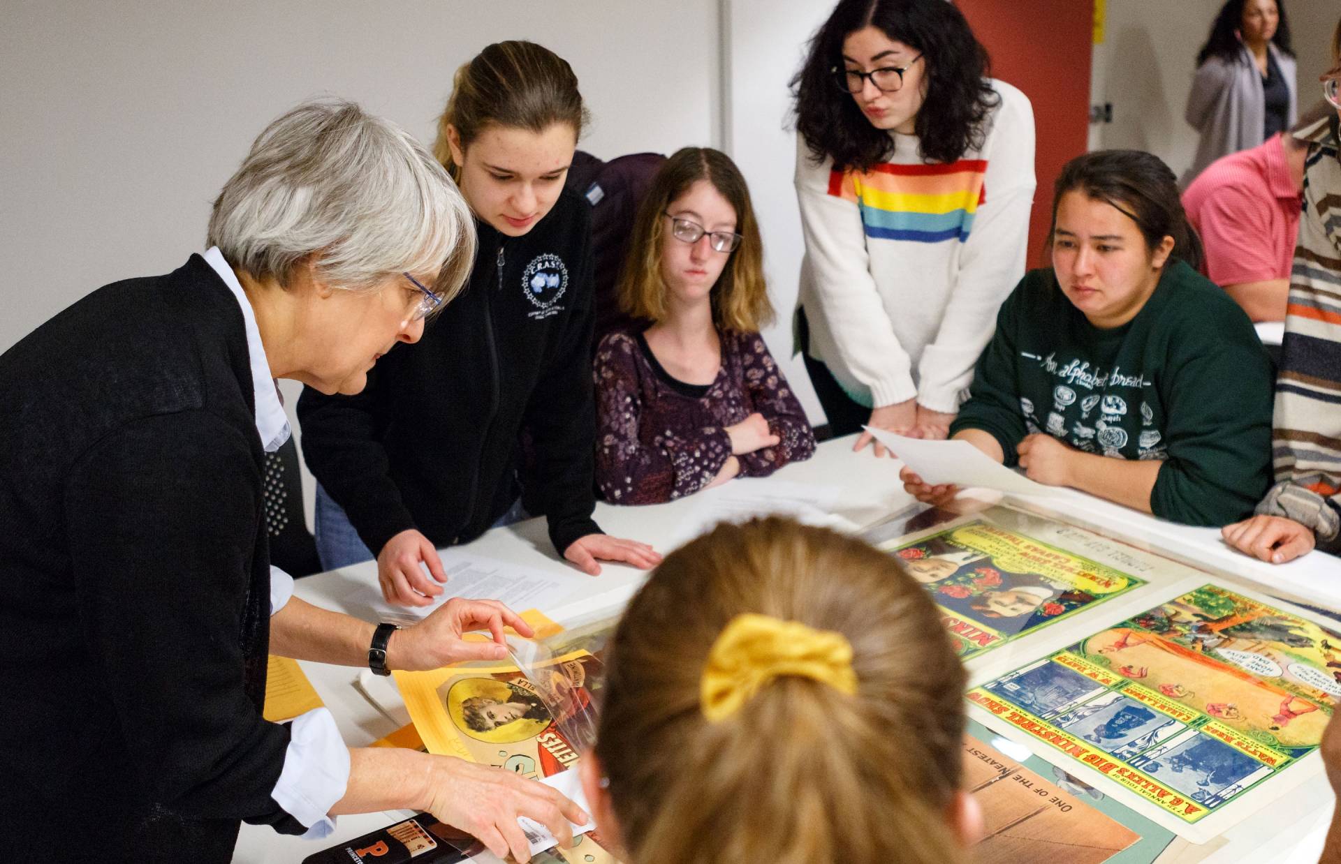 Professor and students look at materials from special collections