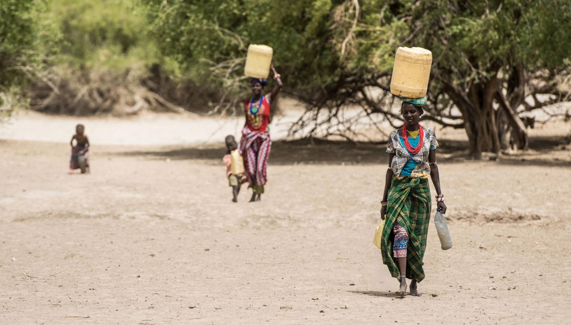 women carrying containers