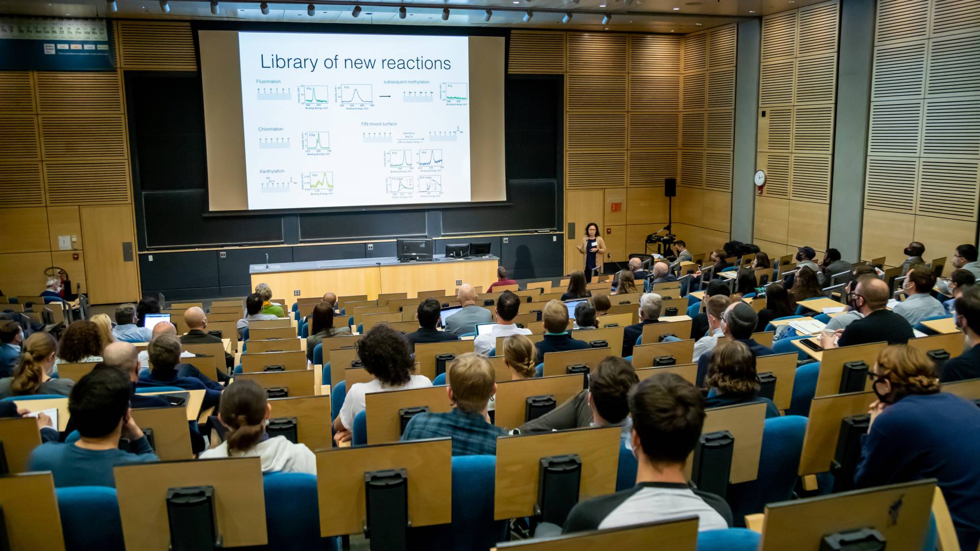 A presenter in a lecture hall