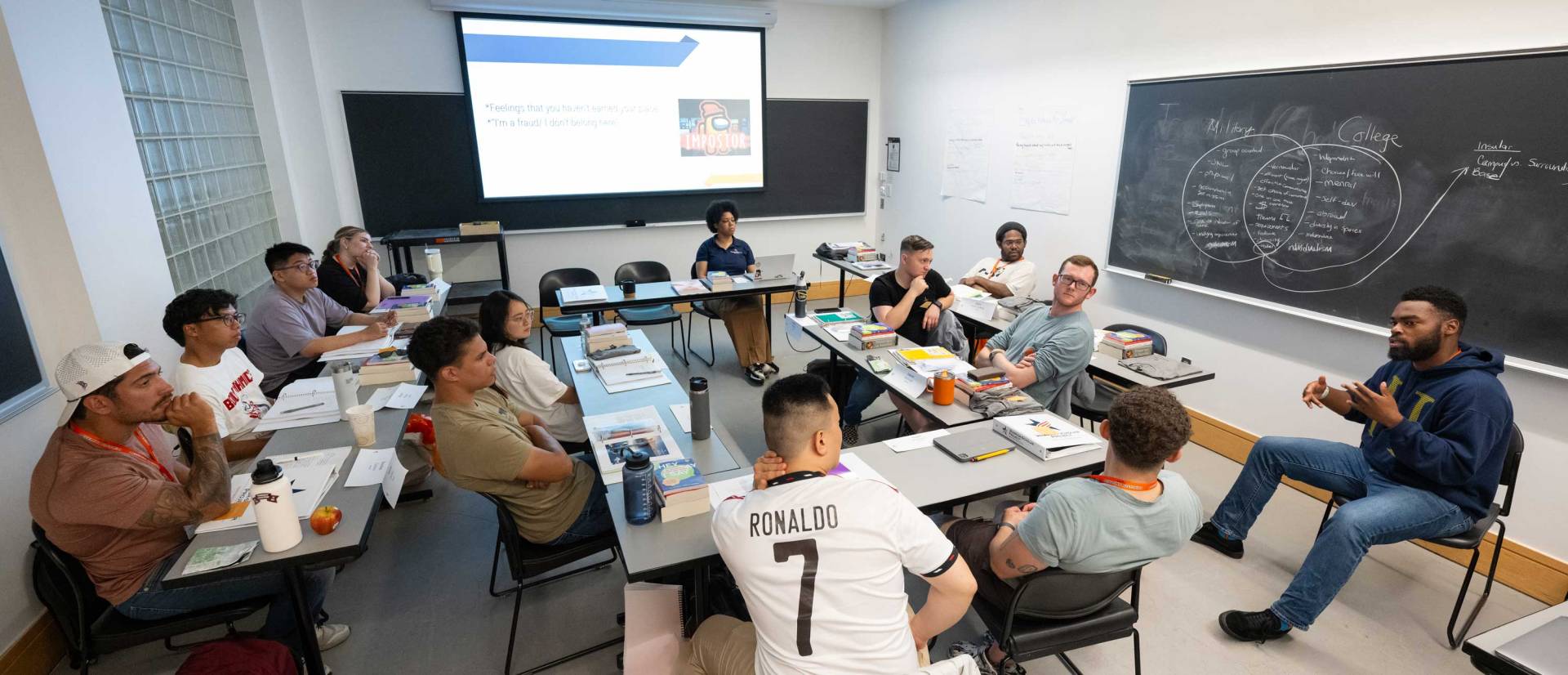 Students in listen to an instructor speak 