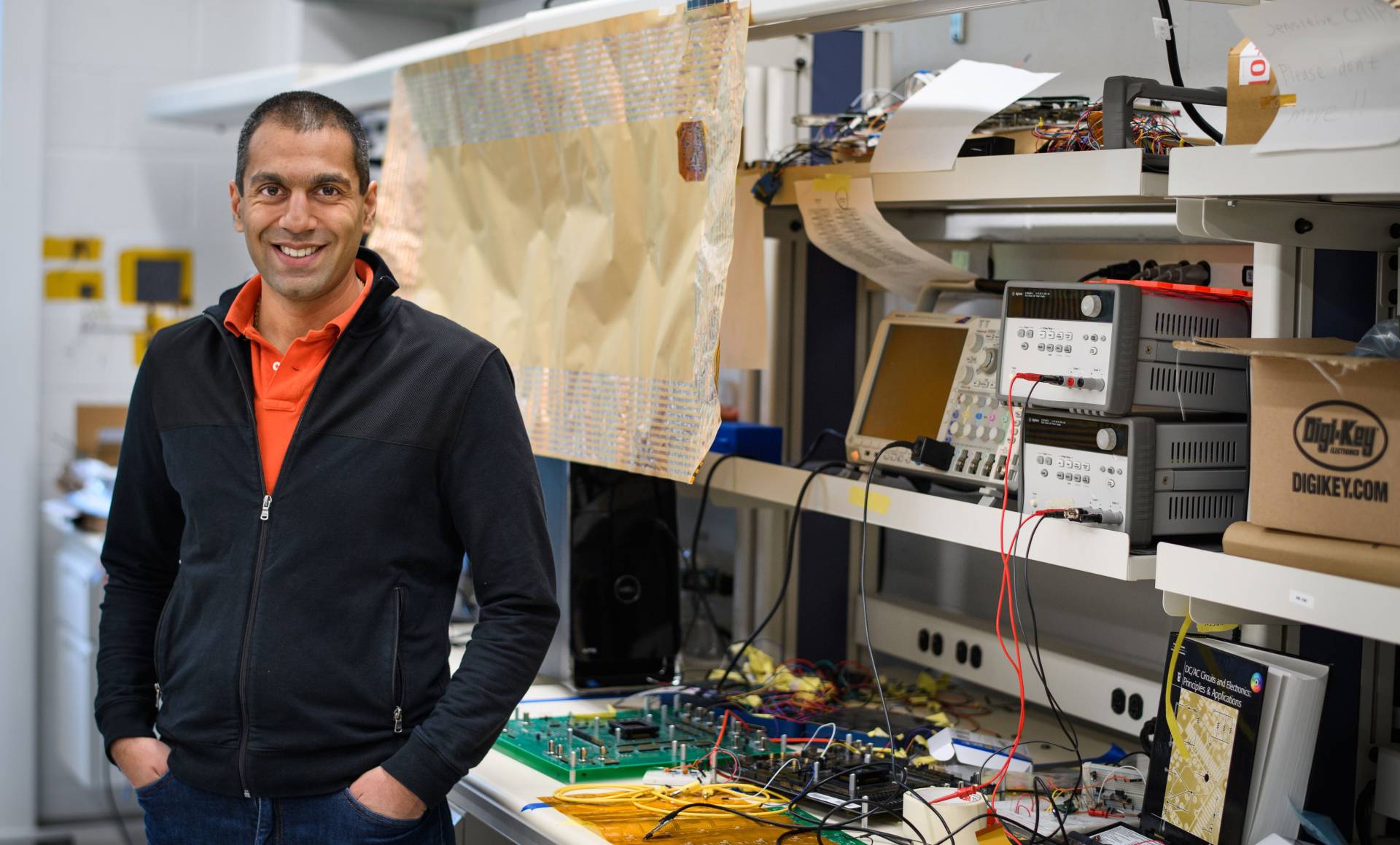 Naveen Verma among his lab equipment