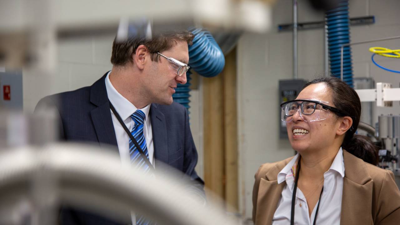 Alastair Stacey and Nathalie de Leon smile at each other in the Quantum Diamond Laboratory.