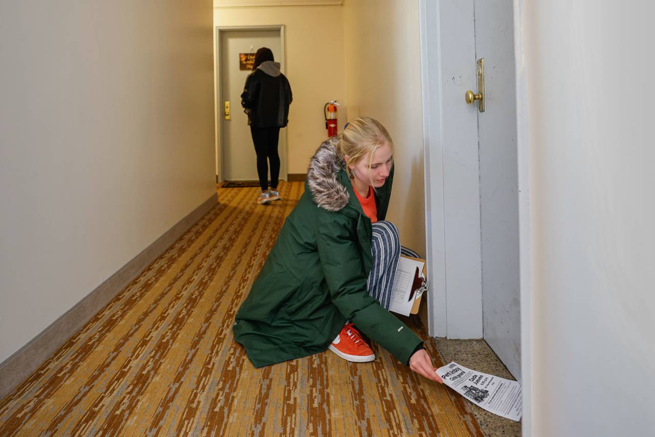 Students leaving flyers in doors