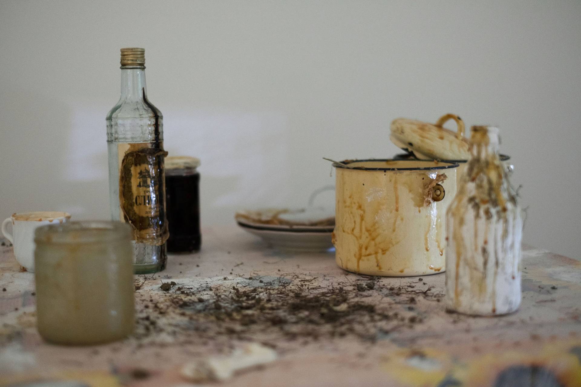 An arrangement of yellowed and well-used bottles and other domestic containers