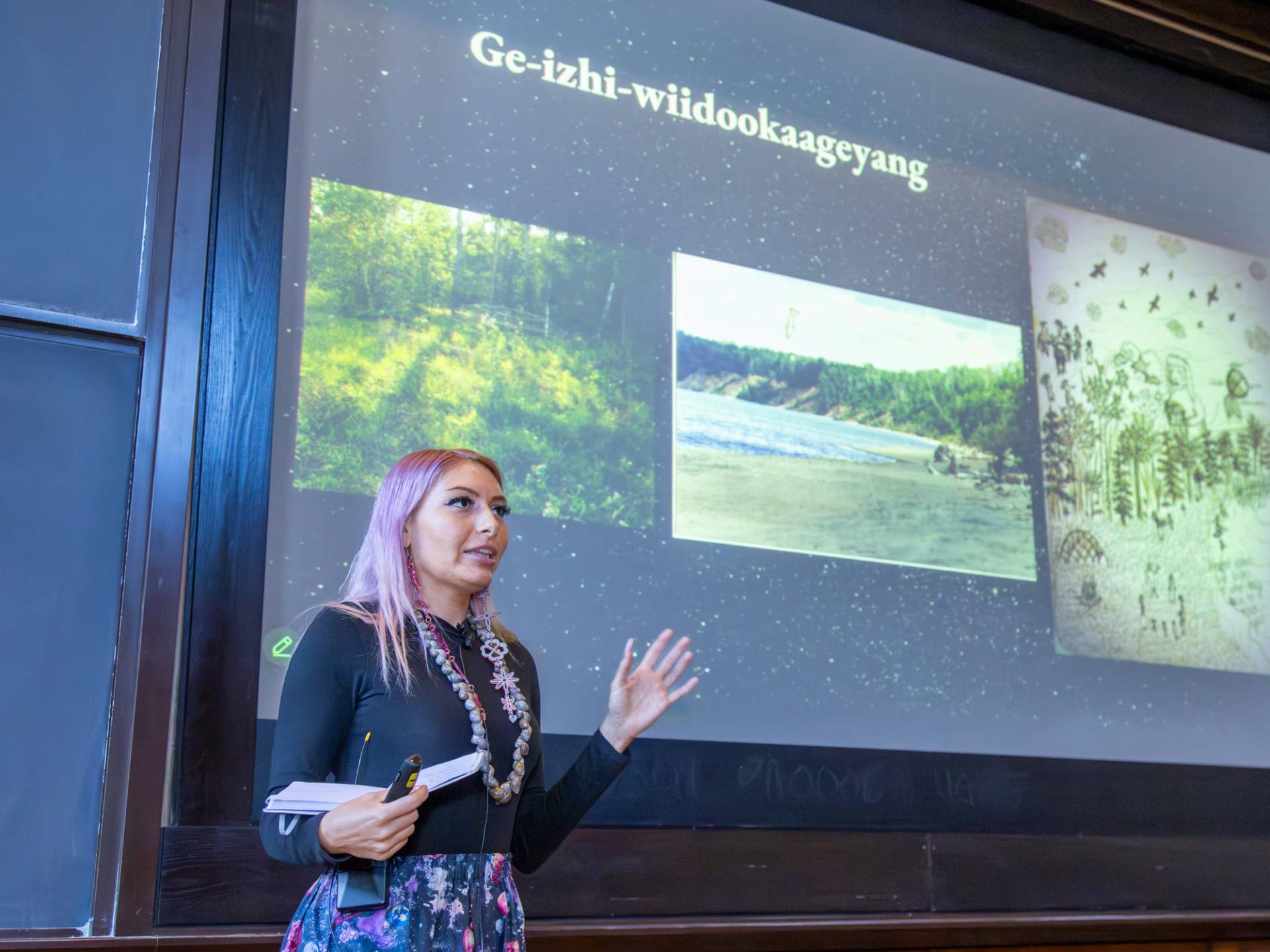 A woman in giving a slideshow presentation