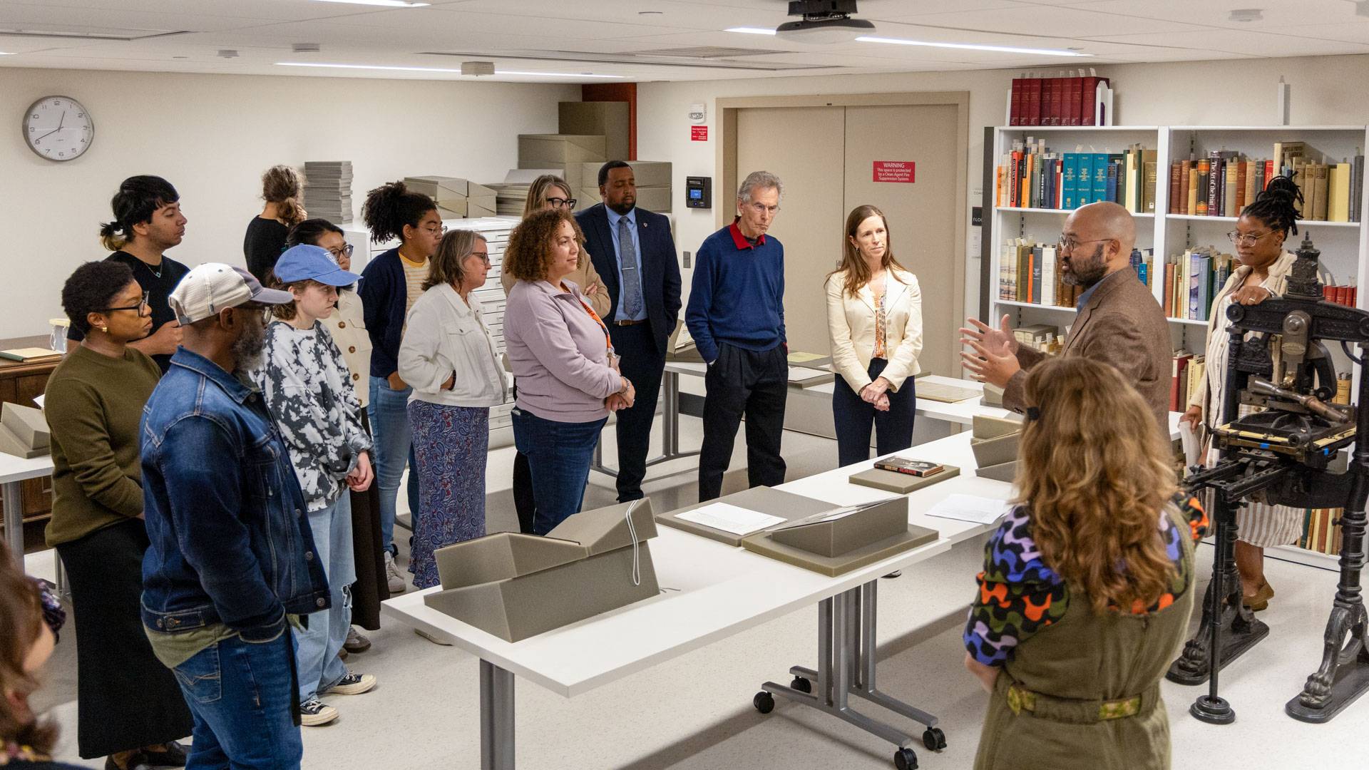 Princeton staff view archival materials in the library.