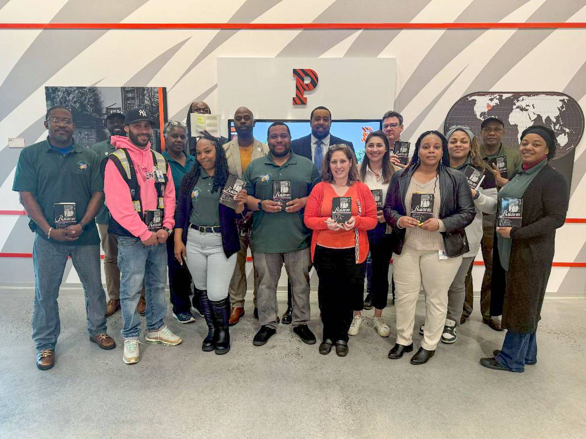 A group of people hold up books