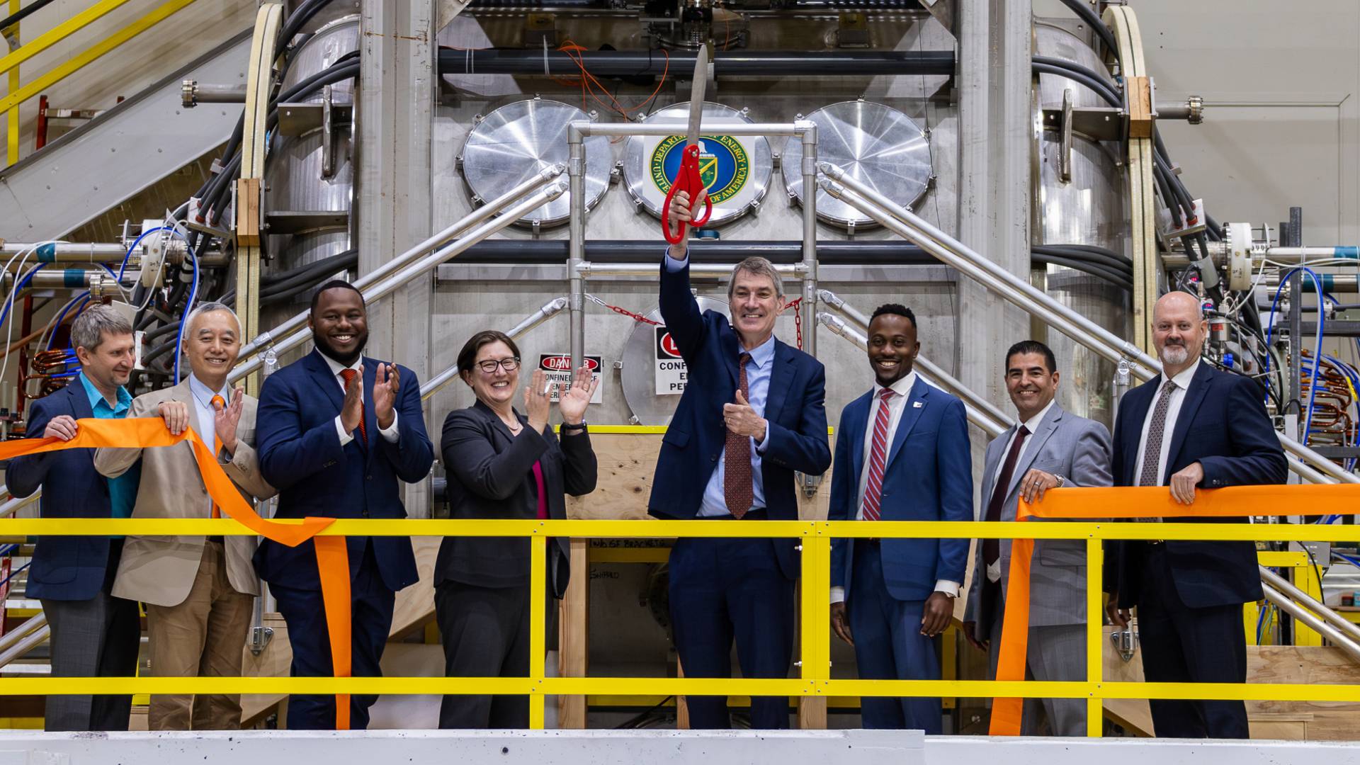 Dignitaries stand in front of the new device, smiling, at the formal inauguration of FLARE operations.