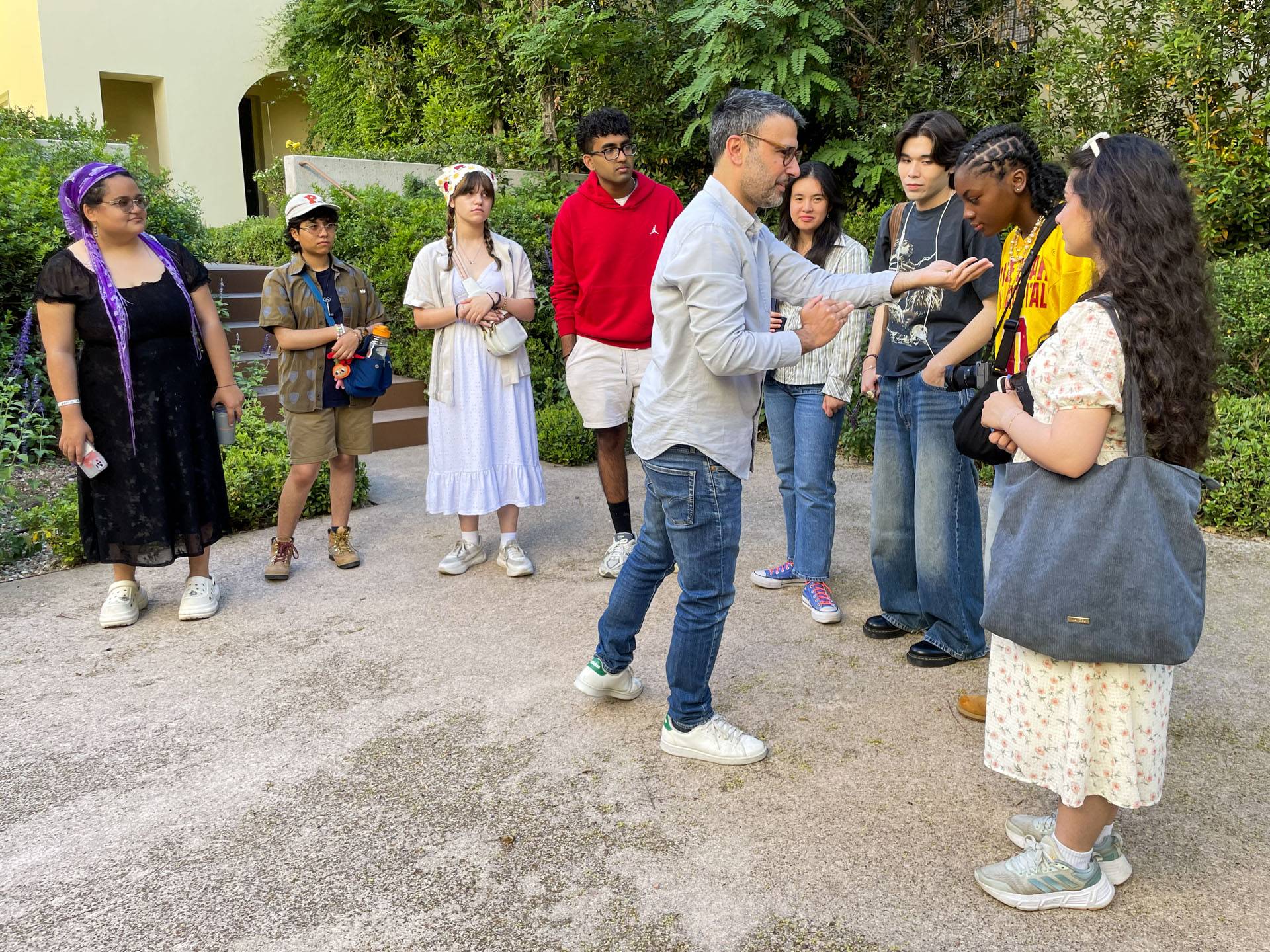Students smell leaves from a mastic tree