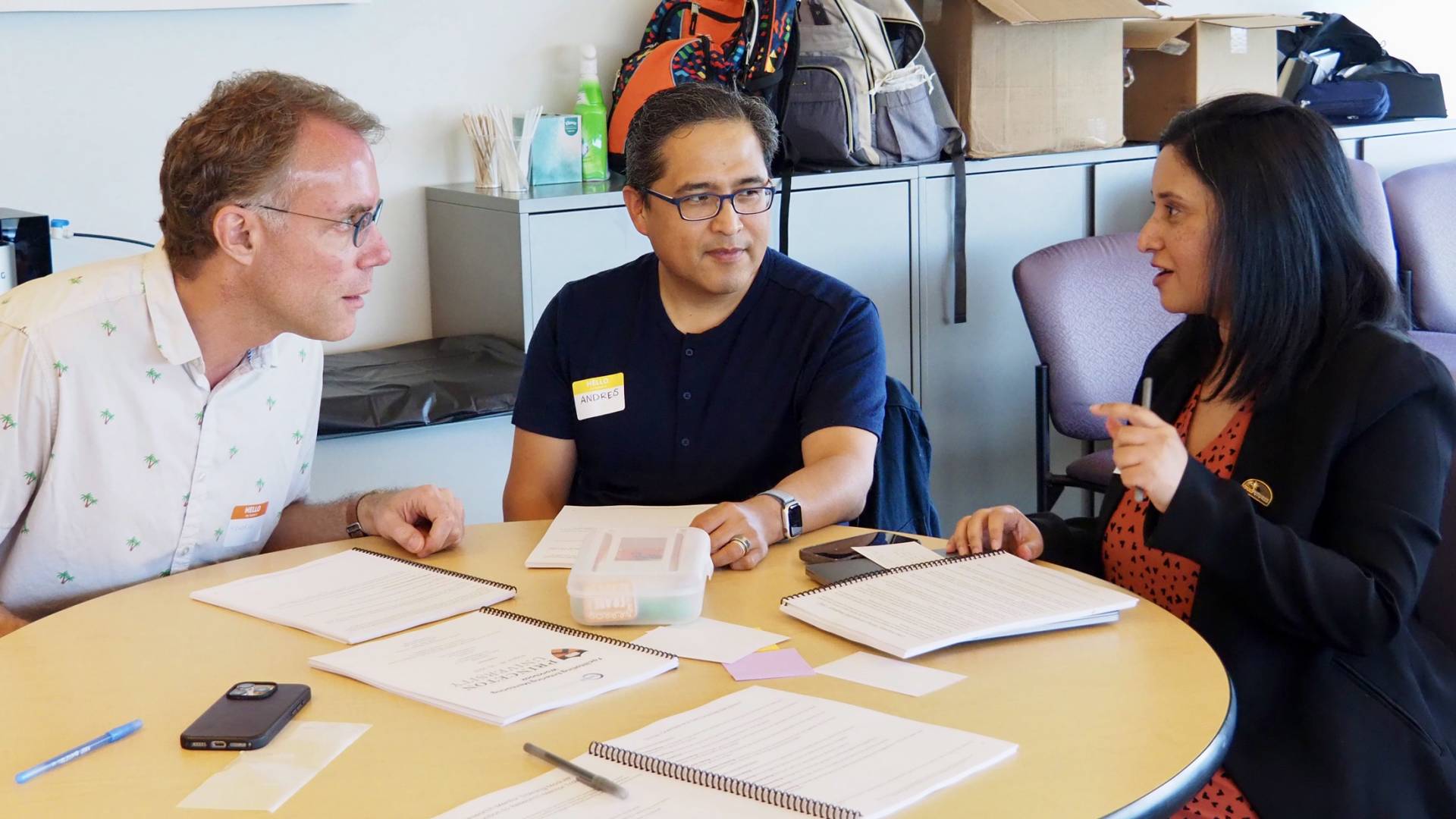 Graduate students sit around a table together during a mentorship workshop