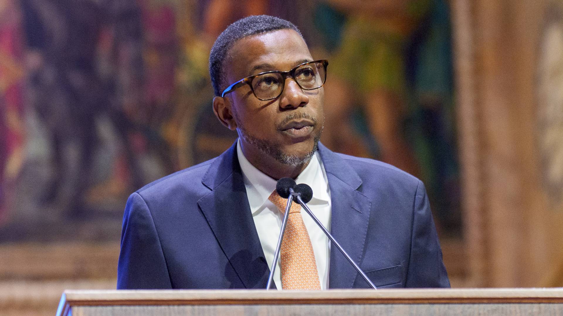 Dean Priestley speaks at the podium.